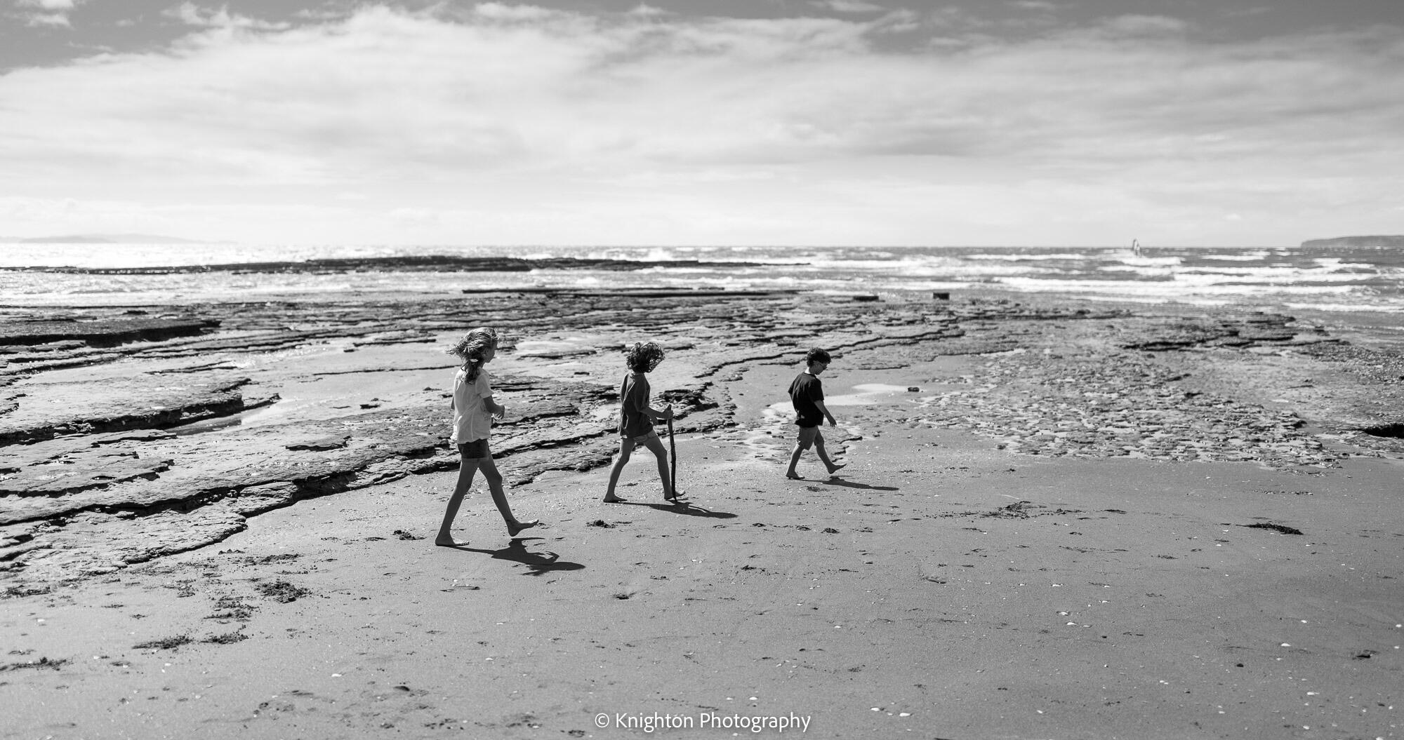 Siblings go for a walk at the beach Siblings go for a walk at the beach